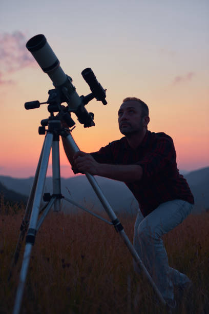 istock Astronomer looking at the skies with a telescope. 1598058132