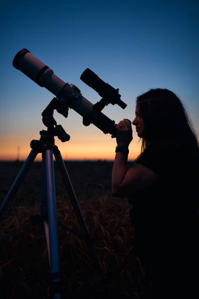 istock Astronomer looking at night sky with a telescope. 1598058174