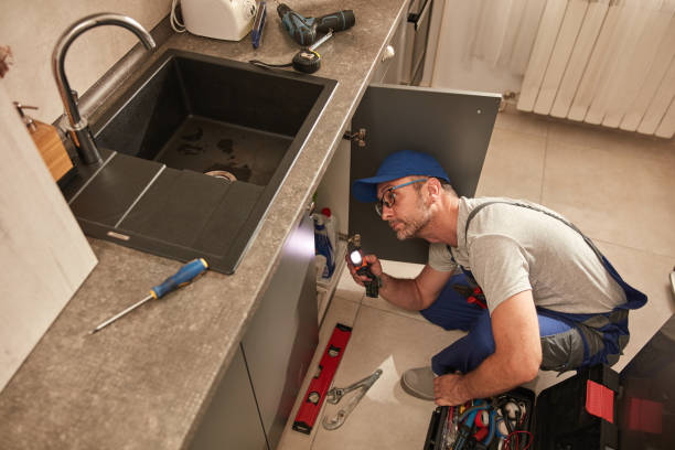 istock Plumber fixing and repairing water pipes under the kitchen sink. 1598074731