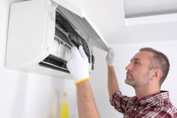istock Service guy cleaning and maintaining air condition unit. 1598075314