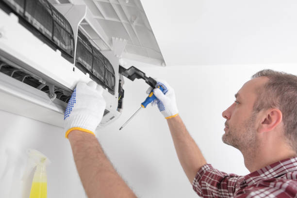 istock Service guy cleaning and maintaining air condition unit. 1598075333