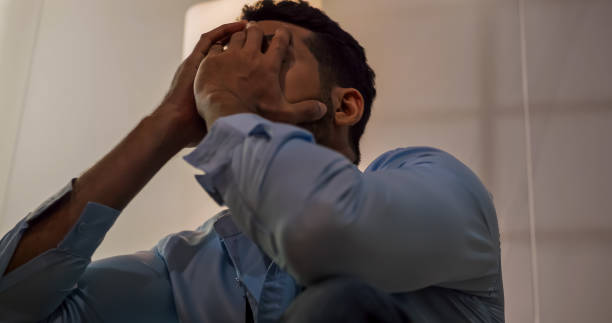 istock A businessman sitting on the floor depressed and stressed with problems in his life. 1598099546