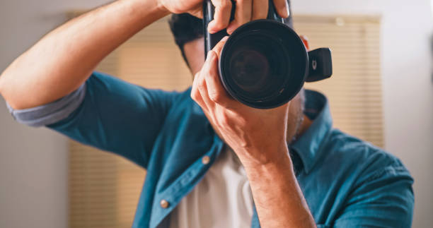 istock Professional male photographer working in studio. 1598100102