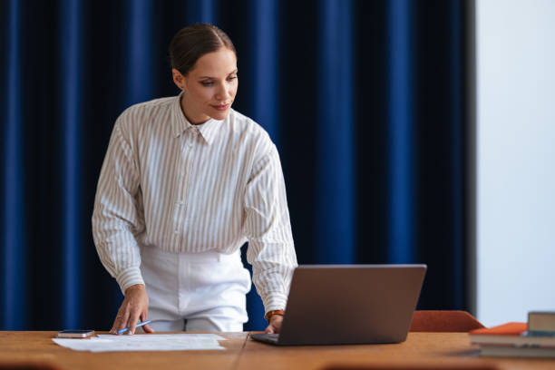 istock Happy Businesswoman Using A Laptop Computer In The Office 1598103446