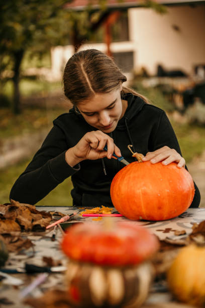 istock Creative girl making a Halloween decoration. 1598111679