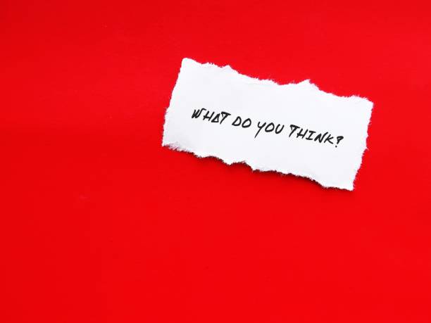 istock Torn note on copy space red wall with text written WHAT DO YOU THINK?, concept of asking for opinion, judgment, viewpoint, comments or feedback from someone which can be agree or disagree 1598113361