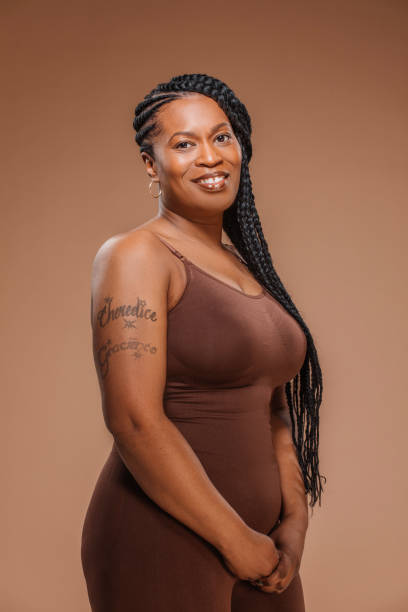 Beautiful adult diverse black female woman posing for studio body positive shot stock photo