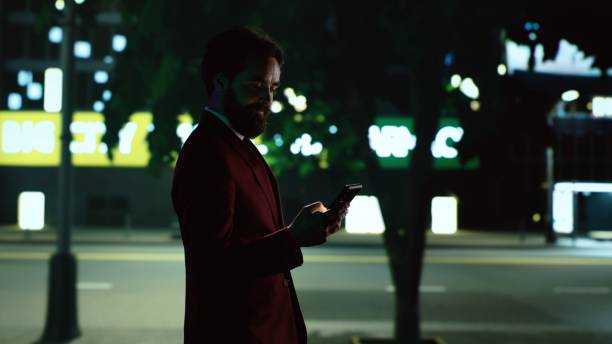 istock Stylish man walking around town at night 1598132072