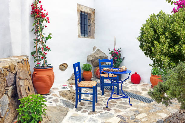 istock typical greek style terrace with table chairs and plants 1598133700