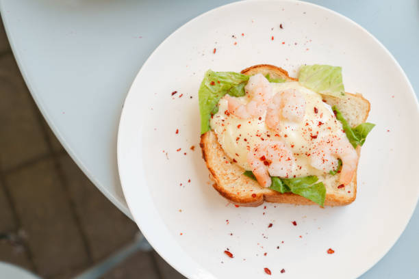 istock Breakfast toast with eggs benedict, sauce and shrimp 1598151230