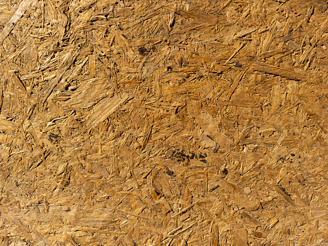 Pressed wood chips board. Wood texture used outdoors.