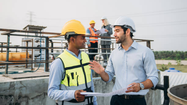 istock Professional Technician Ensuring Pollution Control in Wastewater Treatment Plant. Worker checking the waste water treatment pond industry. 1598159385