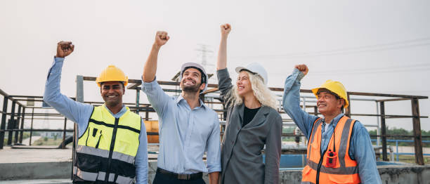 istock Success Stacked and Shake in a Hand. Professional Technician Ensuring Pollution Control in Wastewater Treatment Plant. Worker checking the waste water treatment pond industry. 1598162061