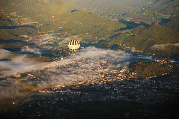 Former medieval town and capital city of Garrotxa located in Fluvia Valley, covered with low-lying fog and illuminated by sunlight.