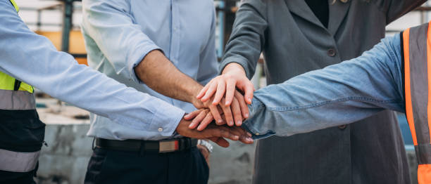 istock Close up Engineer team after success work. Stacked and  Shake in a Hand. Teamwork concepts.Joins hands teamwork meetings. 1598162579