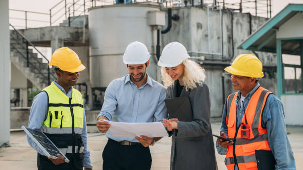 istock Team construction workers discussing project details. Professional Construction Team Meeting for Project Development. 1598163631