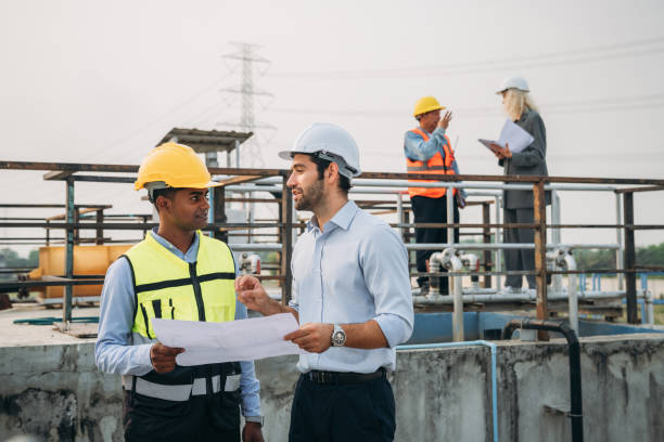 istock Professional Technician Ensuring Pollution Control in Wastewater Treatment Plant. Worker checking the waste water treatment pond industry. 1598165255