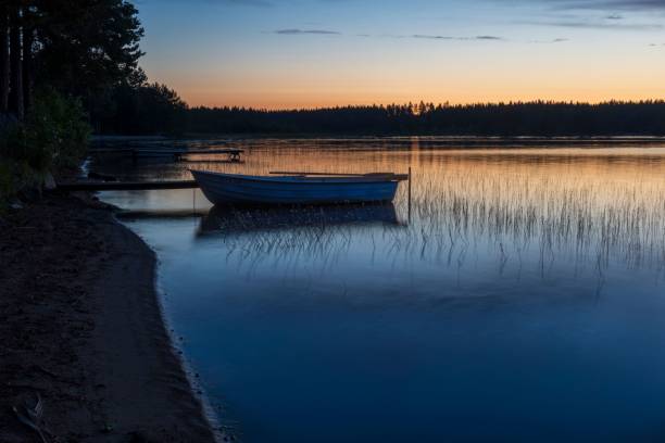 istock Boat docked at the lake shore during the evening. 1598169631