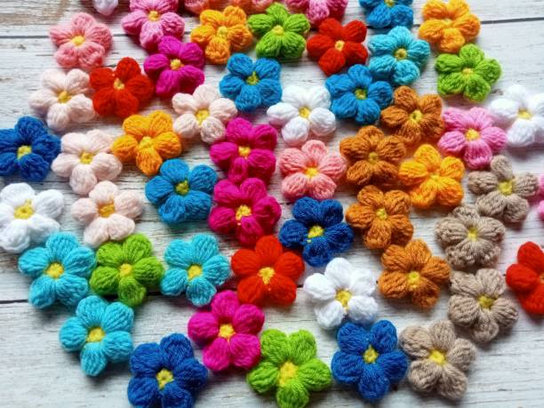 istock Crochet daisy puff flowers handmade multi-color background texture 1598189295