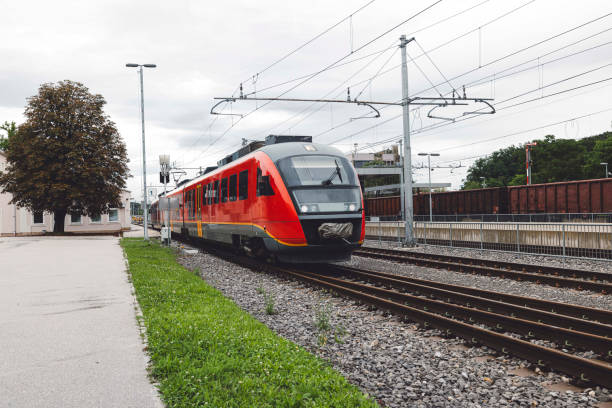 istock Railway station with modern red commuter train 1598198034