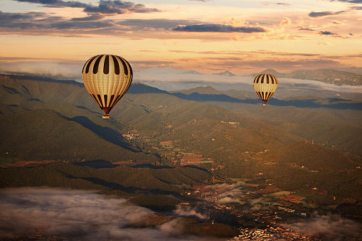 Colorful hot air balloons flying over mountain at sunset. adventure in summer vacation.