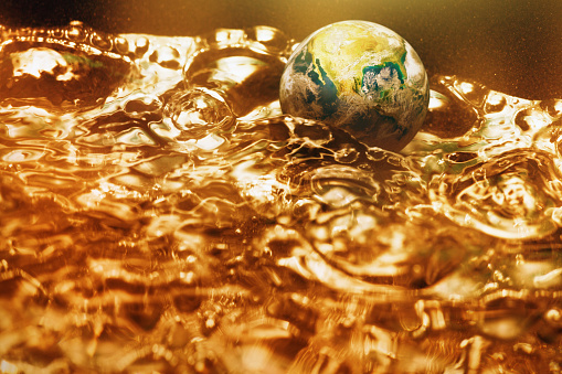 Hot world boiling in a pot of water, symbolizing the climate crisis and the new term 
