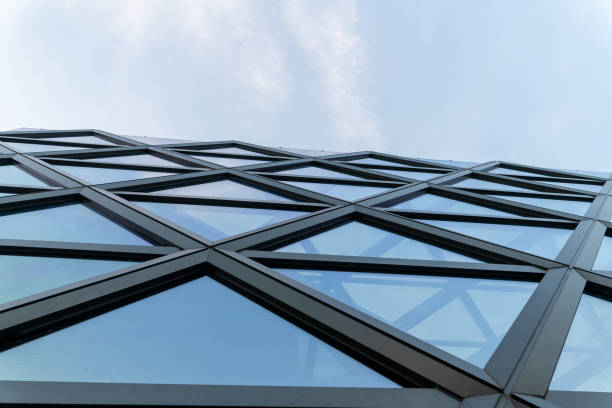 istock empty glass windows at modern building exterior with cloudy sky. 1598214842