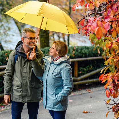 Mature couple enjoying a rainy day on Lake Bled in SLovenia