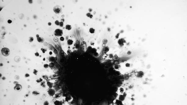 istock Ink stain dirty blot black fluid splash in water 1598237216