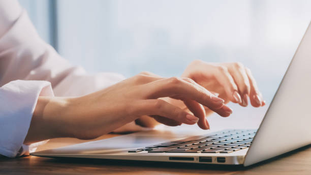 istock Laptop work online business woman hands computer 1598238020