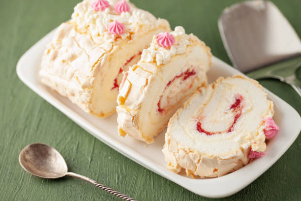 istock Homemade Meringue Cake Sweets Roll with Raspberry jam on ceramic plate. 1598240591