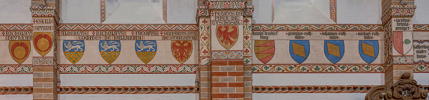 coats of arms in a frieze on the wall in Soro monastery church, Soro, Denmark, July 29, 2023
