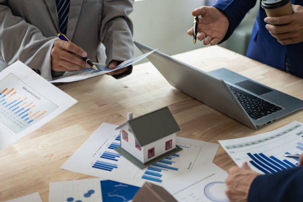 istock Business teams meet in business presentations or seminars. Documents include financial or marketing figures, graphs and charts. There is a laptop on the table. 1598253014