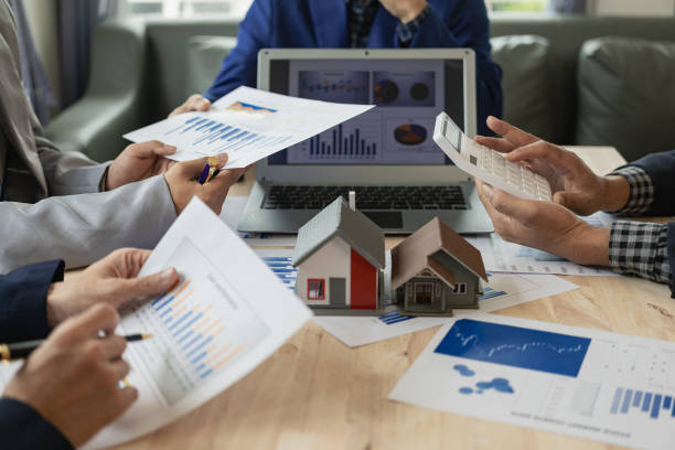 istock Business teams meet in business presentations or seminars. Documents include financial or marketing figures, graphs and charts. There is a laptop on the table. 1598253548