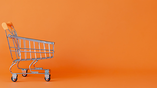 Shopping cart on orange background