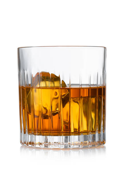 istock Old fashioned glass with whiskey and ice cubes on white background. 1598261575
