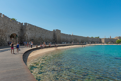 Rhodes, Greece - September 8, 2014: Mandraki port in Rhodes Town, Greece, in the foreground and St Nicholas fortress in the background, UNESCO World Heritage Site, Rhodes City