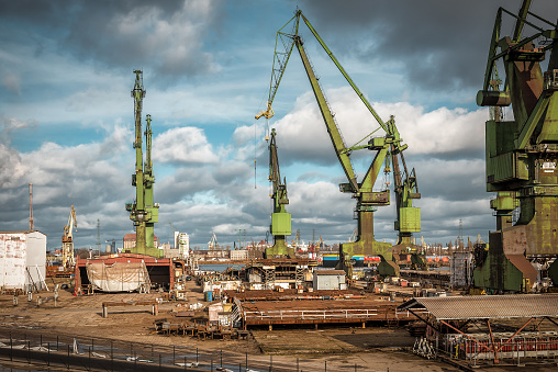 Large historical port cranes in the industrial part of the city. Industrial theme