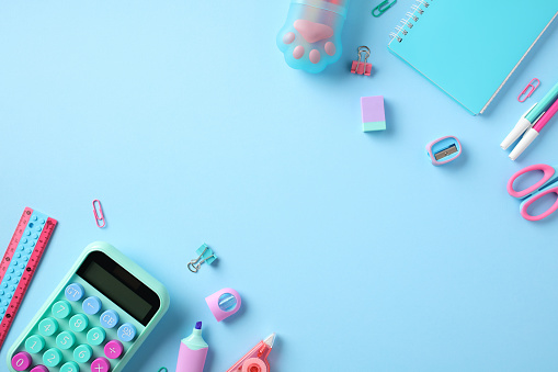 Back to school concept. Stylish school supplies on pastel blue background. Flat lay, top view.