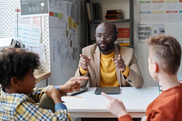 istock Teacher talking to students at school 1598302346