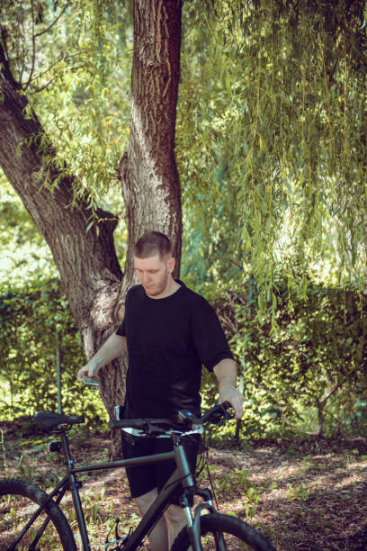 istock Male Getting Ready To Ride Bicycle Again After Break 1598305667