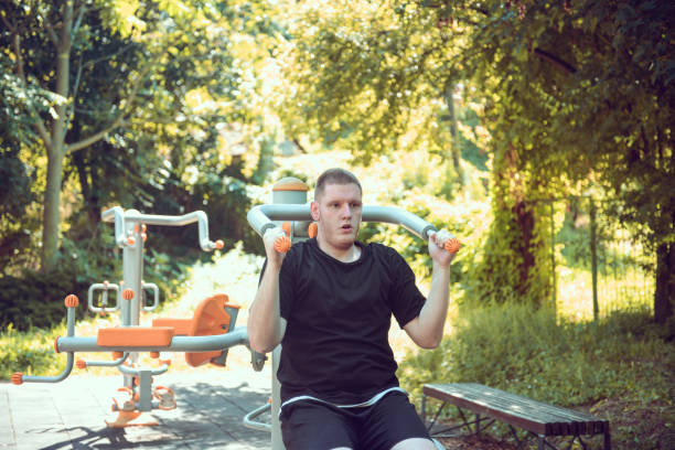 istock Single Male Using Pullup Equipment At Outdoor Gym To Get In Shape 1598306228