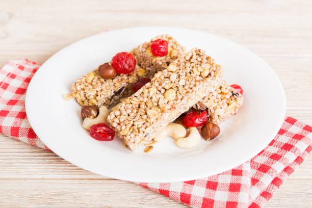 istock Various granola bars on table background. Cereal granola bars. Superfood breakfast bars with oats, nuts and berries, close up. Superfood concept 1598307302
