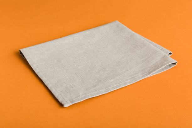 istock top view with gray kitchen napkin isolated on table background. Folded cloth for mockup with copy space, Flat lay. Minimal style 1598308941