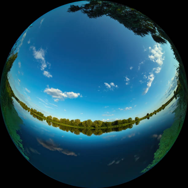 Wide angle view of a river with calm water on a summer day through a circular fisheye lens stock photo
