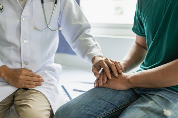 istock doctor and patient discussing symptoms Discuss problems with patients about medicines and treatment methods, diagnose, sit down and talk. At the table near the window in the hospital medicine concept 1598362088