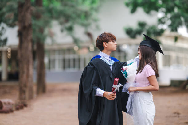 istock Triumphant Moments: A Young Asian Couple's Graduation Celebration 1598375139