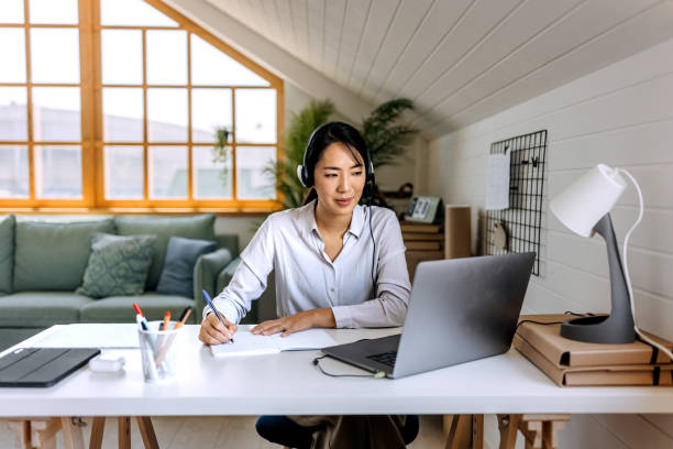 istock Young beautiful businesswoman taking notes while working at home office 1598401823