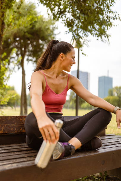 istock Woman jogging outdoors, hydrating 1598402910