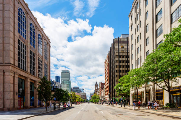 Boston, Massachusetts, USA - July 30, 2023: Westward view down an empty Boylston Street in Boston's Back Bay neighborhood. Boylston Street is a major eastwest thoroughfare in the city of Boston. In the distance are the Prudential Center skyscraper and the bell tower of the Old South Church.